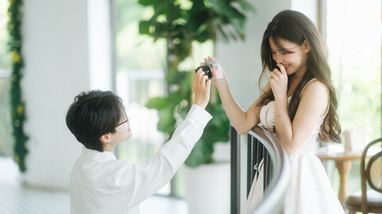 A heartfelt marriage proposal in a lush indoor setting, capturing romance and surprise.