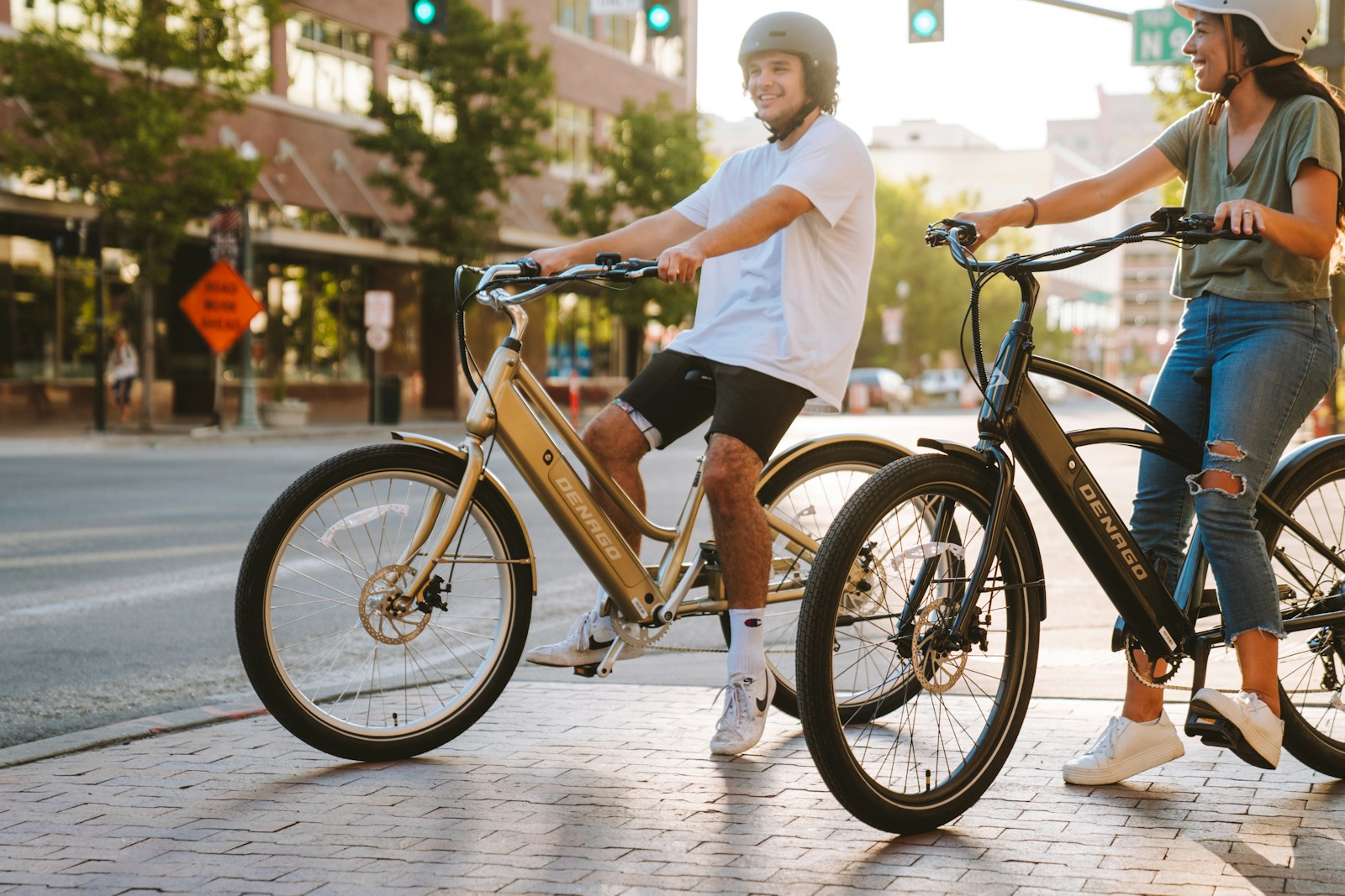 a couple of people riding bikes down a street
