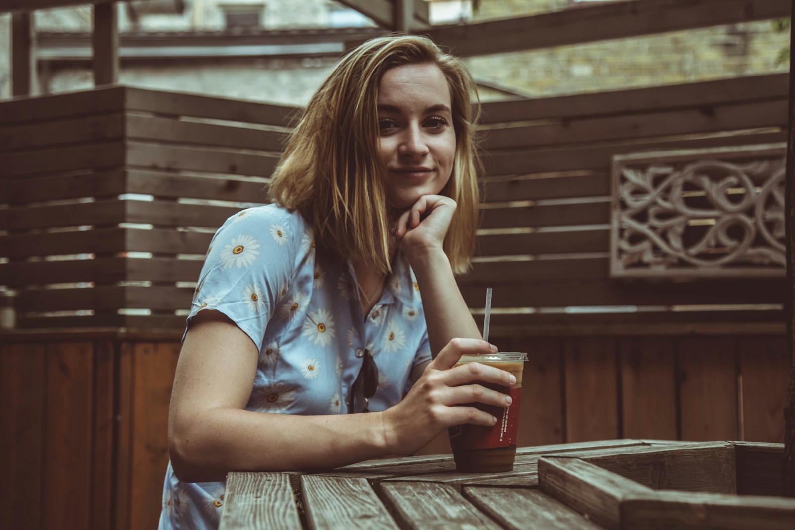 woman placing her left hand under chin while sitting