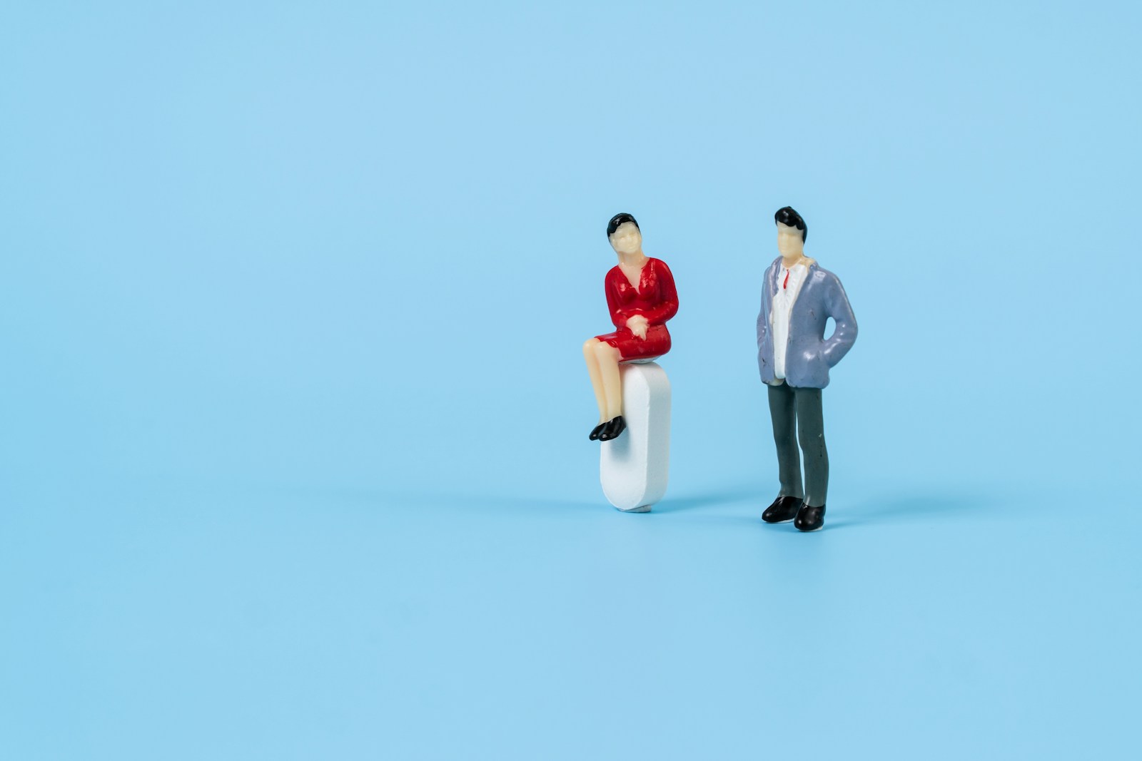 a man and a woman on a white object