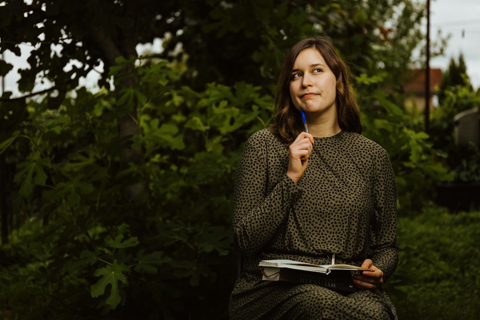 A woman sitting on a bench holding a blue toothbrush