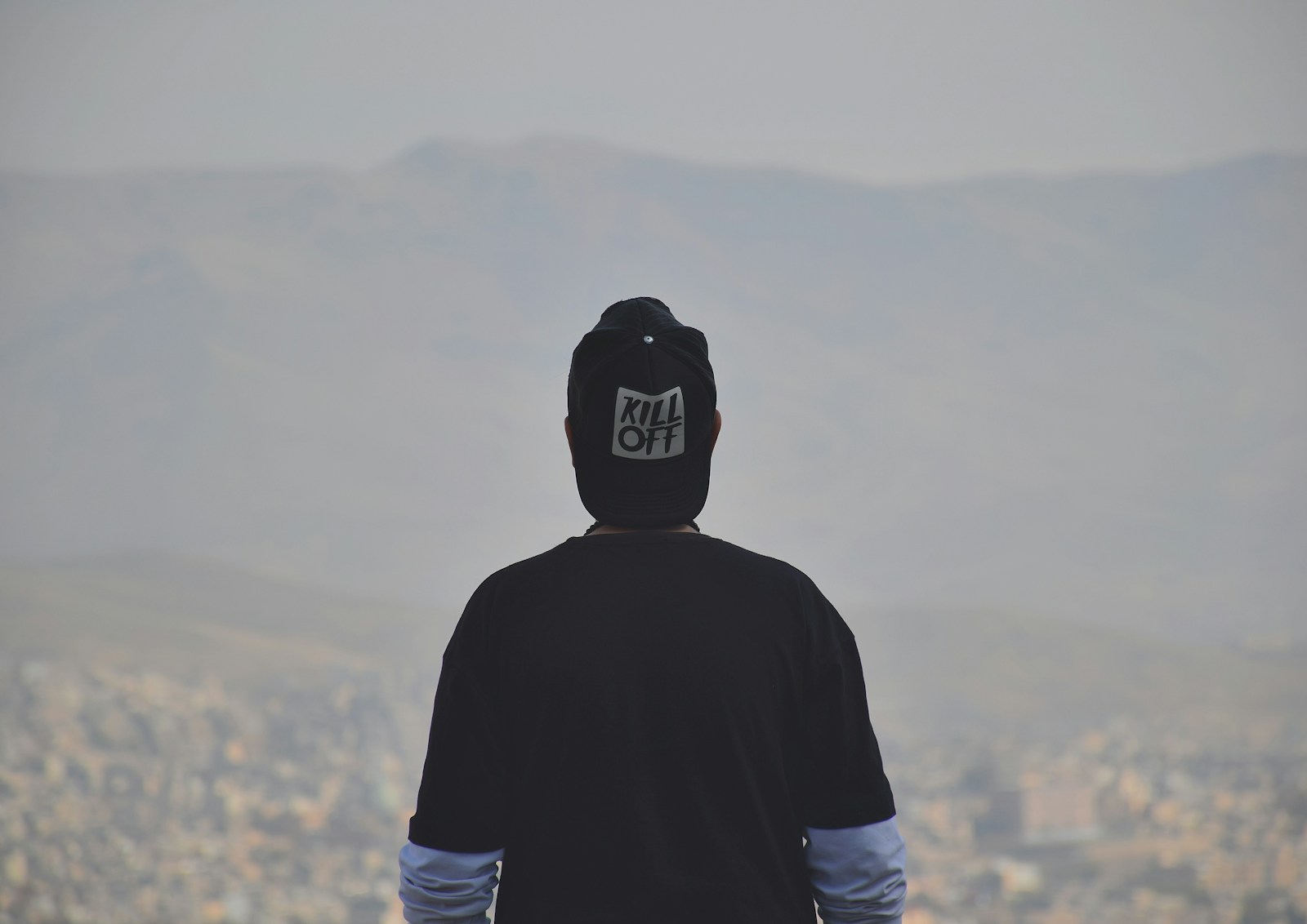 man in black and white hoodie wearing black and white cap