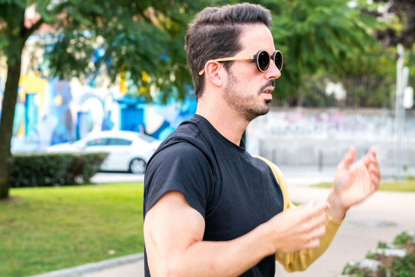 A man wearing sunglasses and holding a frisbee