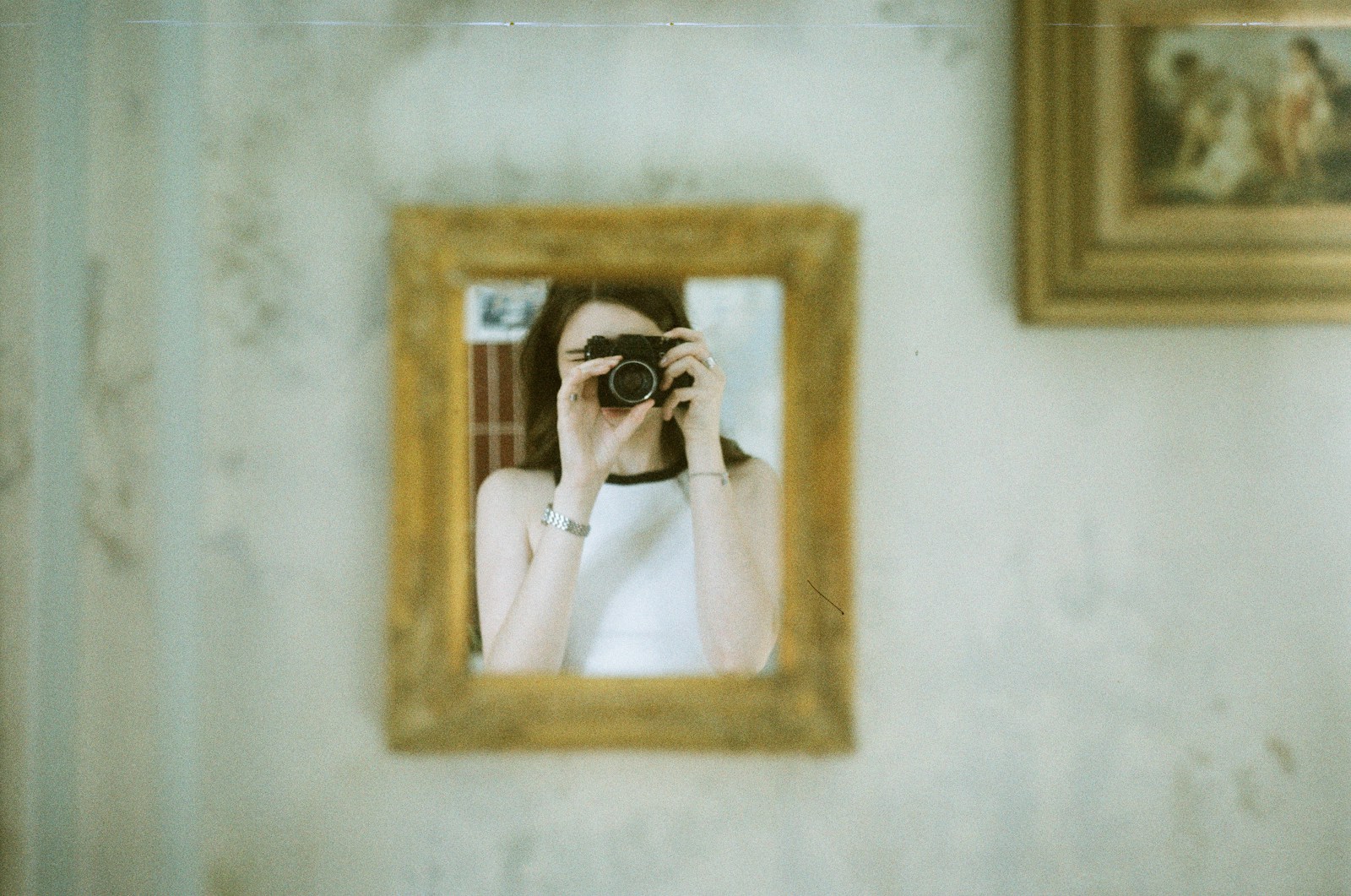 A woman taking a picture of herself in a mirror
