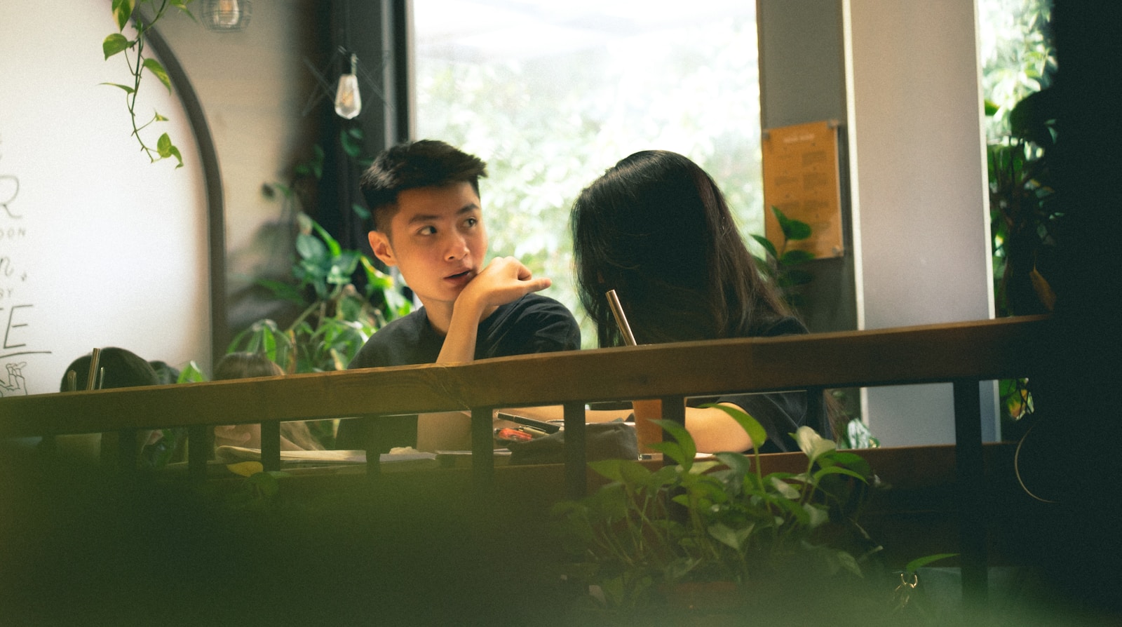 a boy and girl sitting at a table