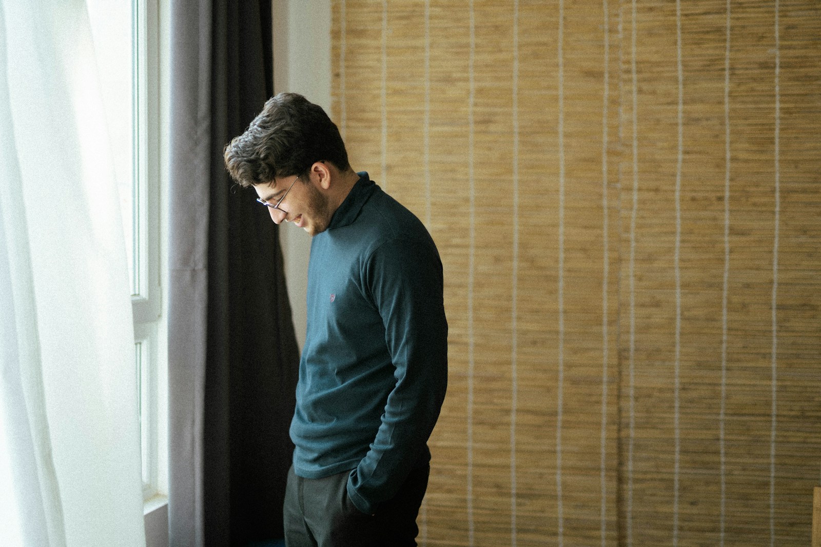 a man standing in front of a window